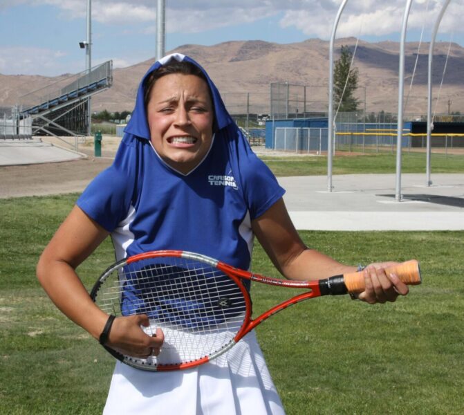 McGowan jokingly strums her tennis racket for a photo.