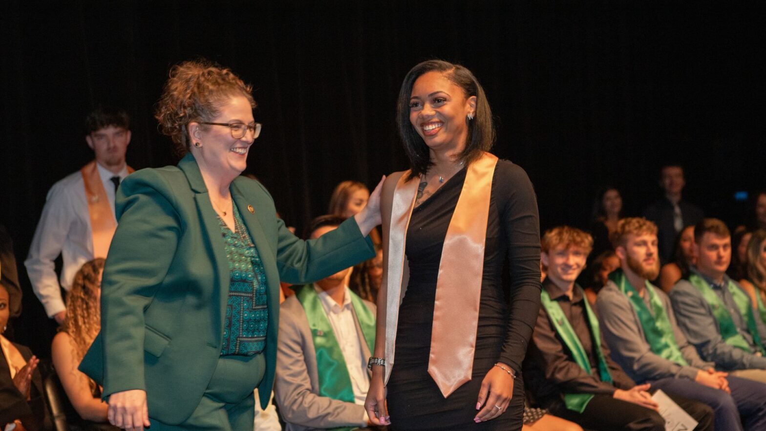 Tyrell congratulates nursing graduate Ashliegh Tarver as she crosses the stage.