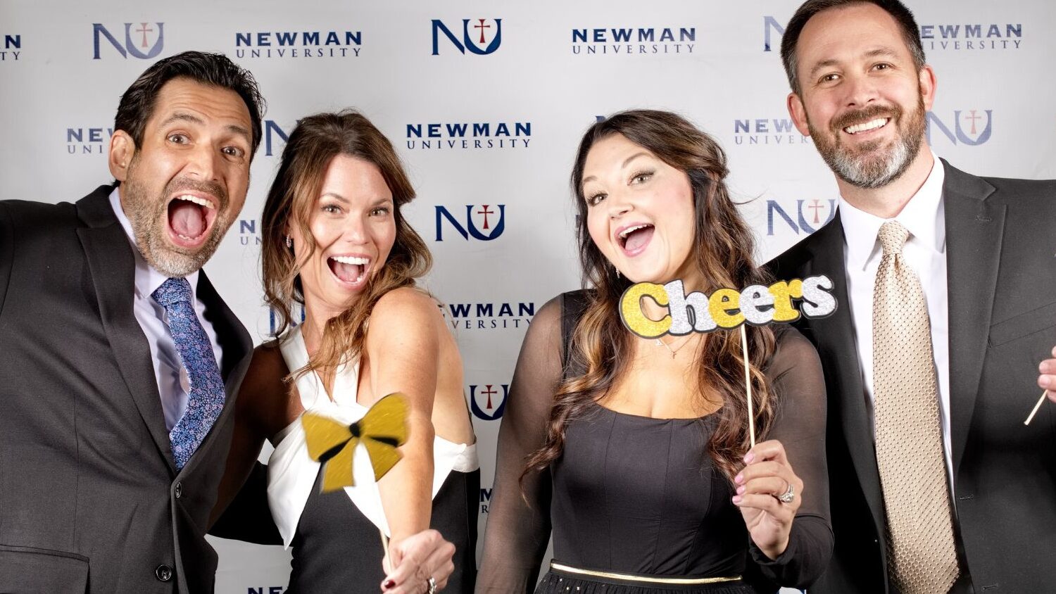 Faculty and their family members pose at the photo booth.