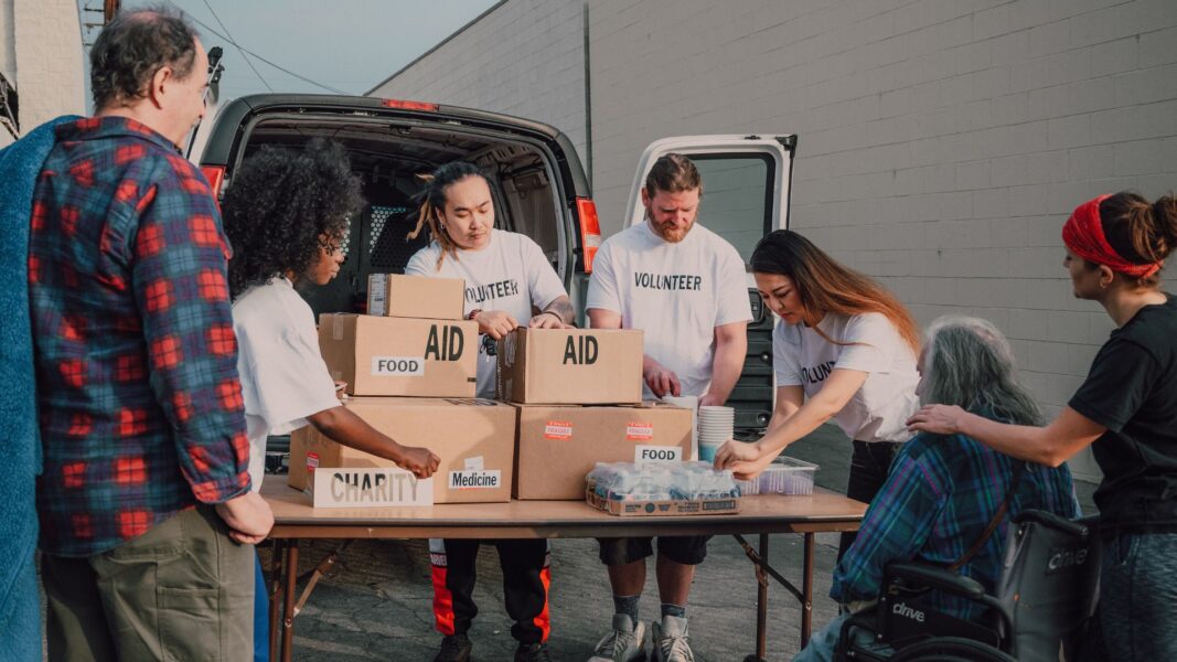 Volunteers hand out food and other necessities to those in need