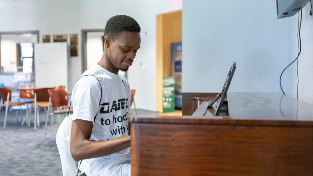 Lotsu-Morgan plays piano in the Student Activities Center in between classes at Newman.