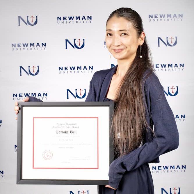 Bell holds up her excellence award