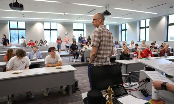 Newman Honors Program Professor Kelly McFall meets with students.