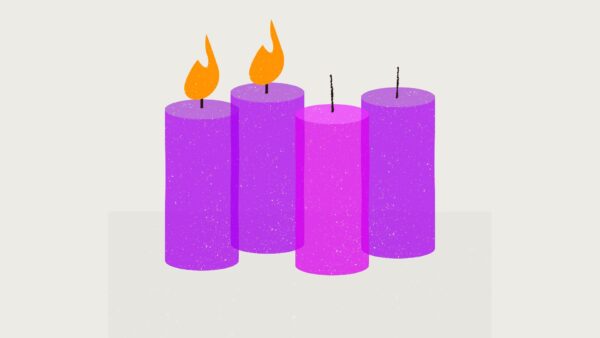 Two purple candles are lit for Advent, while a pink and purple one are left unlit for the coming weeks.