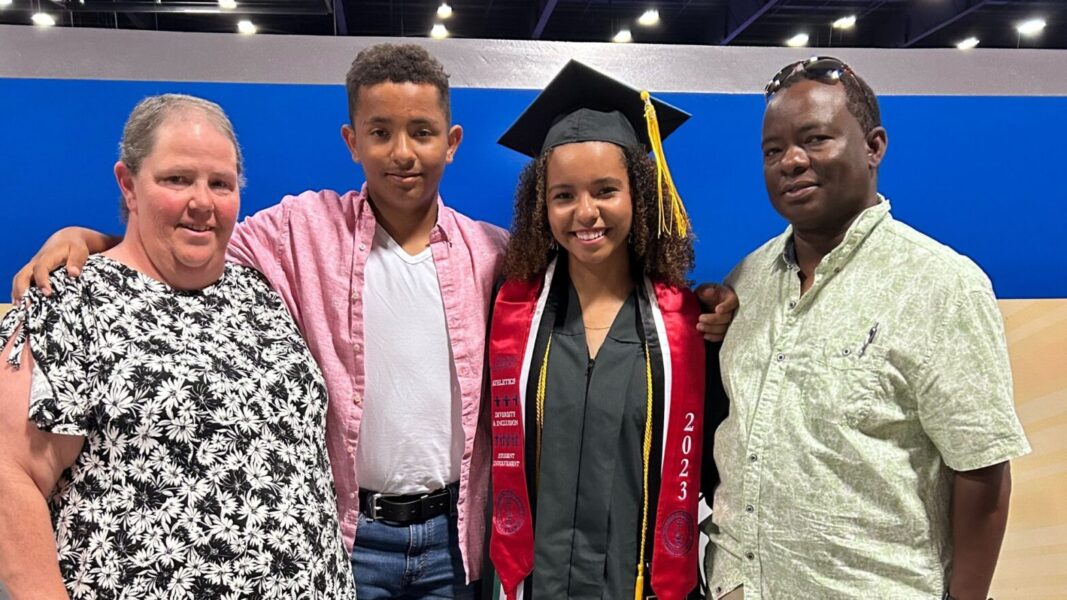 (From left to right) Mwangi's mother, brother, Mwangi and father attend her graduation from Newman University in 2023.