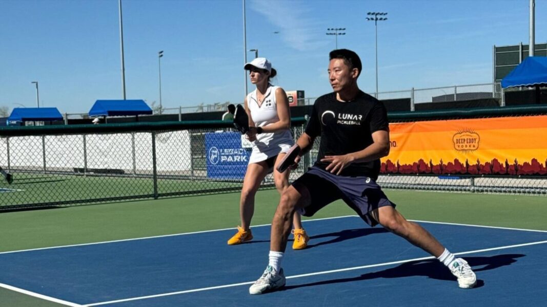 Evgeniy Kim plays pickleball with a teammate