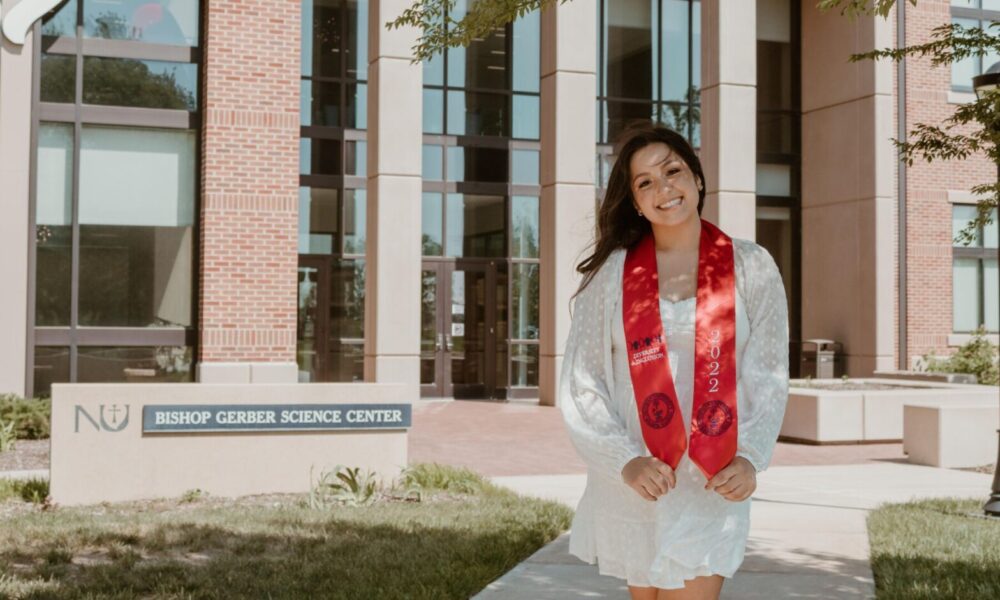 Nicole Romero standing in front of Bishop Gerber.