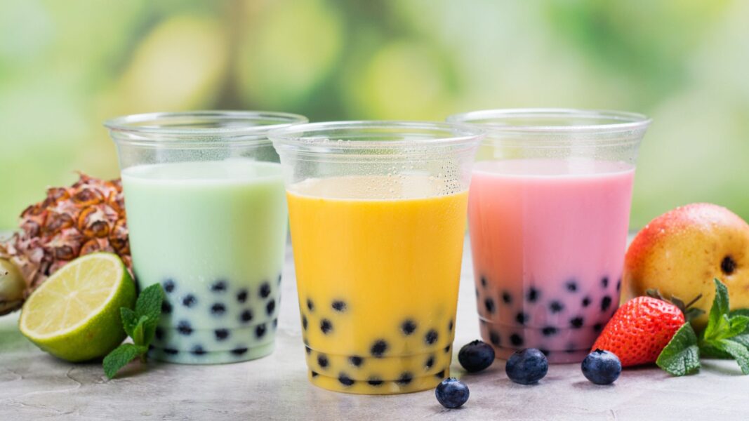 boba in green, yellow, and pink milk tea