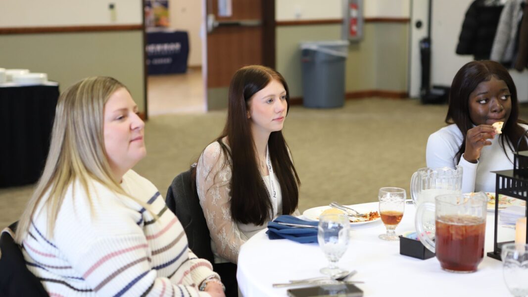 A student listens as speakers share details about Newman University in the Dugan-Gorges Conference Center.