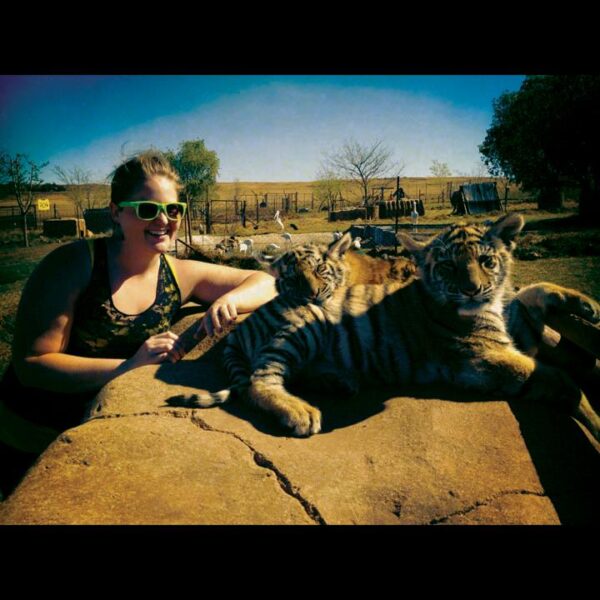 Evans with baby tigers during her mission trip, The World Race.