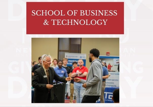 Professor Larry Straub awards a student with a raffle prize during a business mixer at Newman University.