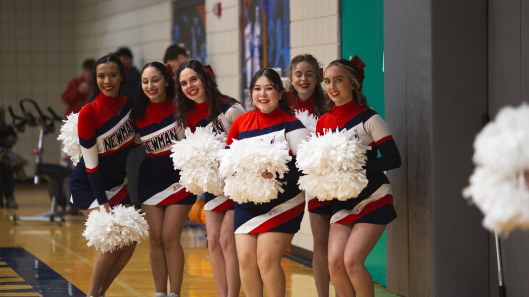 Fuentes (center) in her cheer uniform alongside teammates.