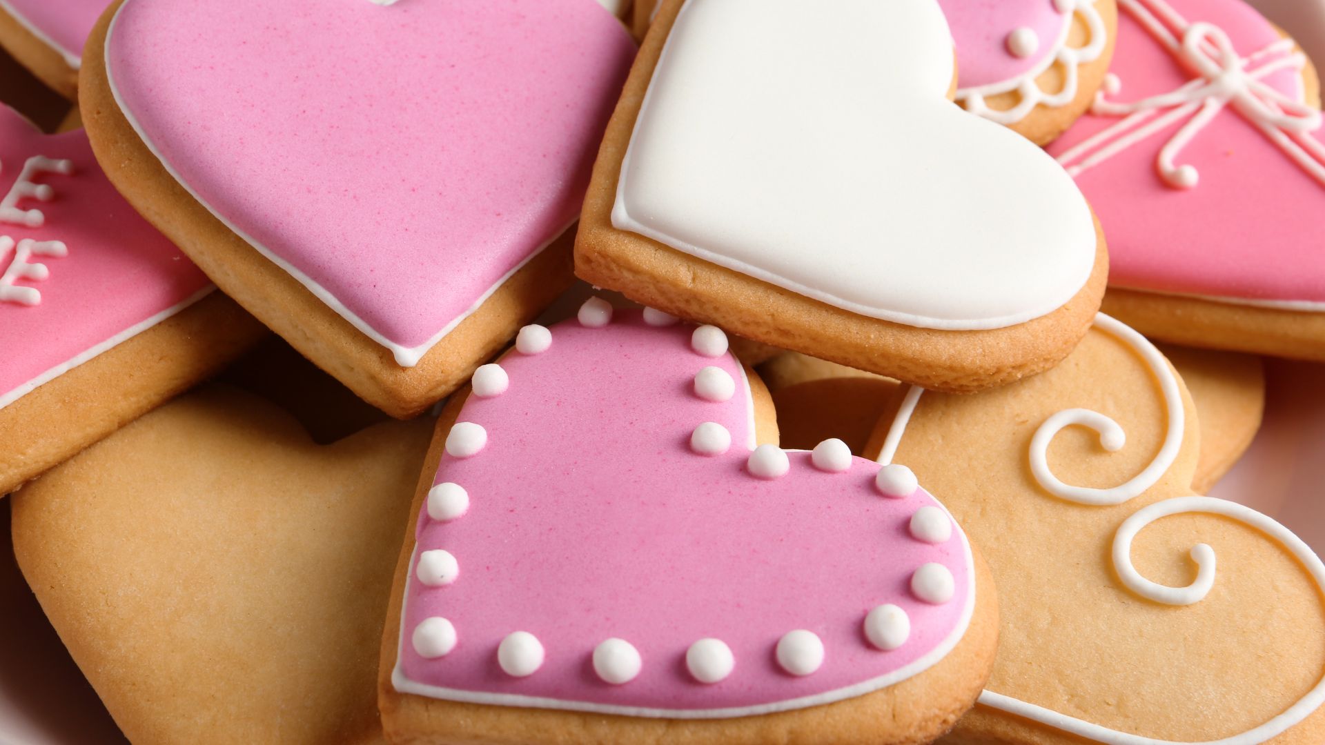 heart shaped sugar cookies with pink and white frosting