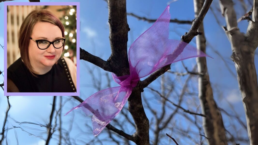 Suzanne Berg's picture and a purple ribbon on the redbud tree in her honor