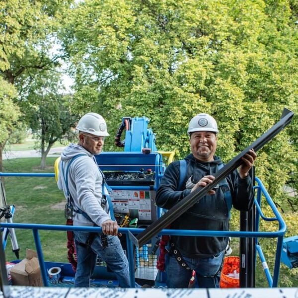 Simpson Construction crew members smile outside of the third floor windows.