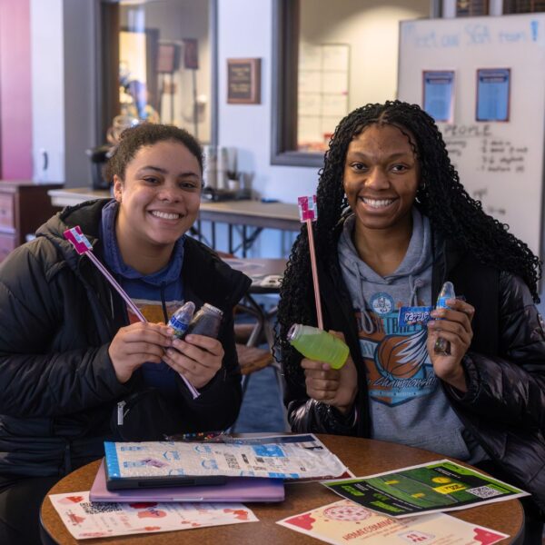 Students hold up Pixie Stix candy on Nostalgia Day.