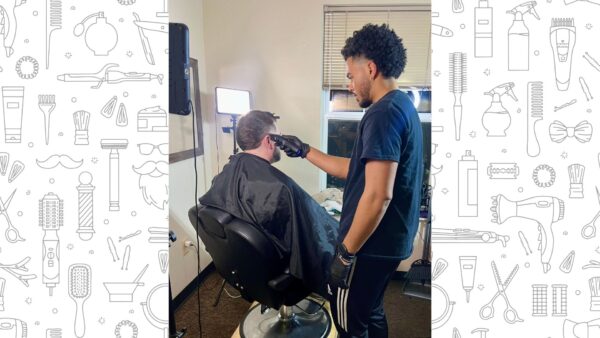 Chadwick cuts a student's hair in the residence halls.