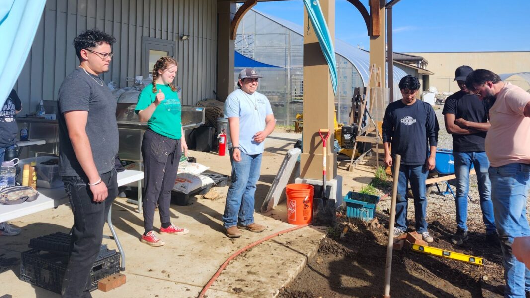During their service week, students made a drainage path to help water drain from the produce wash station to ponds on the farm.