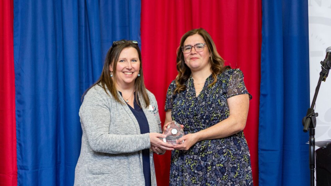 Director of Alumni Relations Dana Beitey presents McWilliams with the St. Maria De Mattias Award.