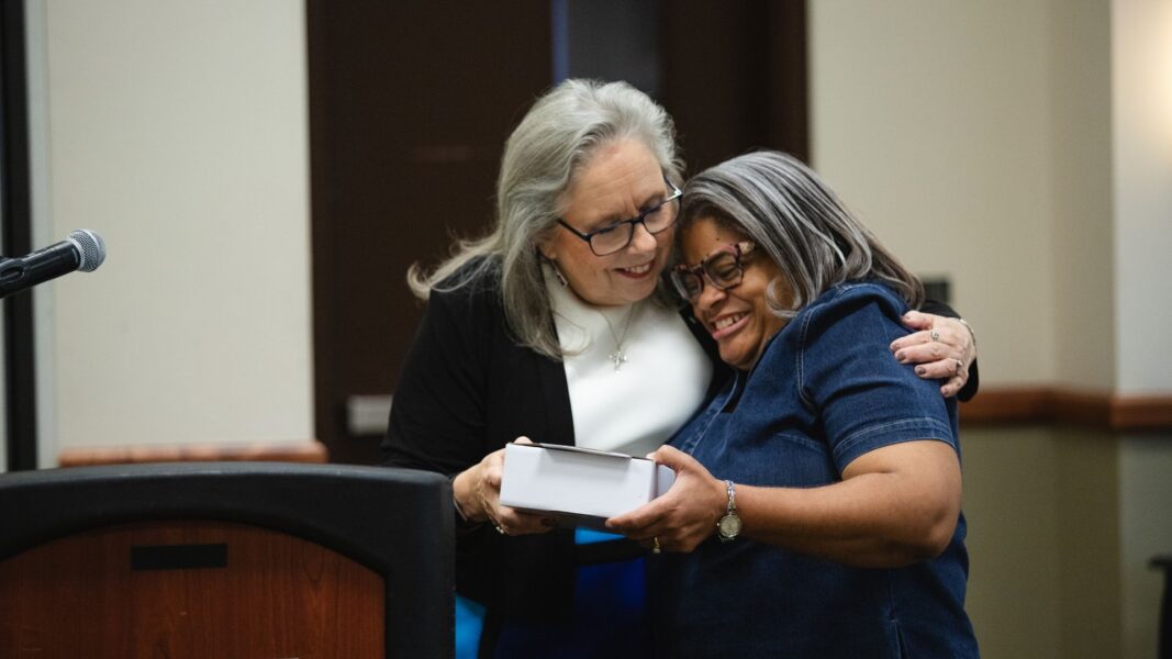 President Jagger congratulates Davis with the 2025 staff excellence award.