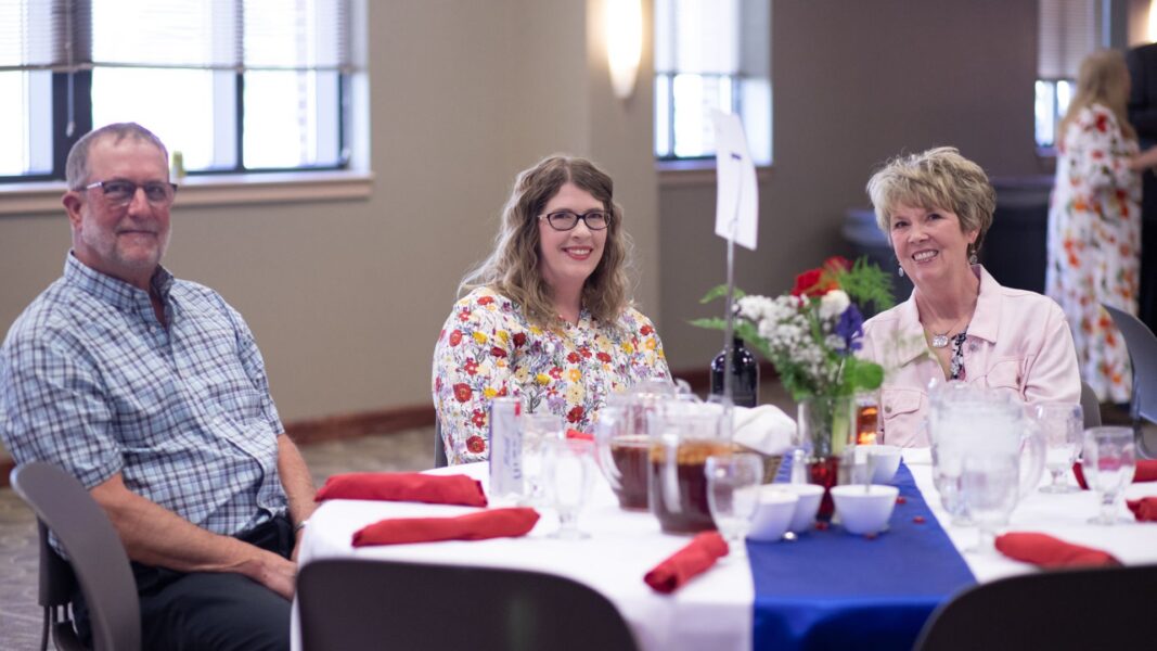 Lies sits with her parents during the Legacy Banquet in April.