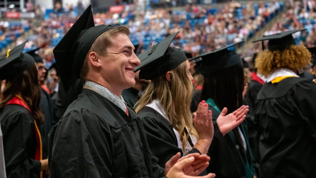 Sponsel and fellow graduates of the class of 2025 applaud as they are welcomed into the Newman Alumni Association.