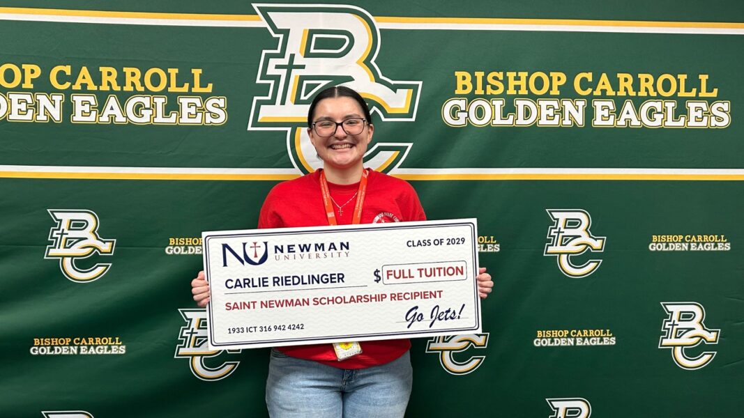 Riedlinger with her giant check in the amount of "full tuition" to Newman University