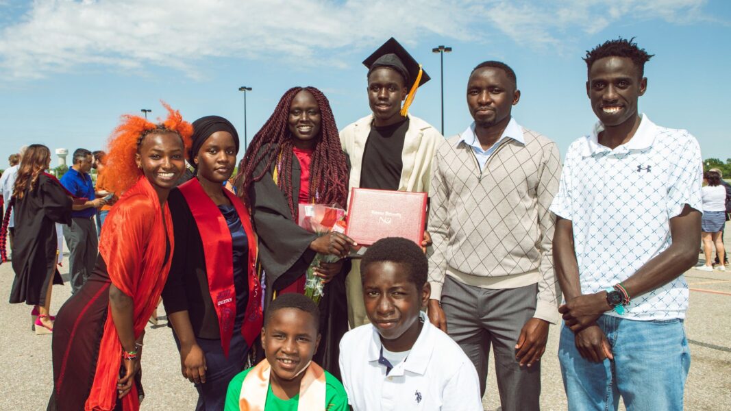 Limo and her family, including her husband (second from the right), on Newman graduation day