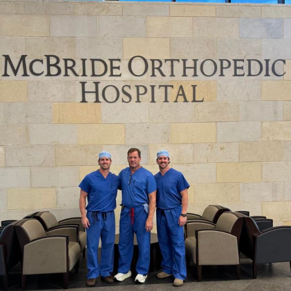 The Rawls family members stand in front of the McBride Orthopedic Hospital sign in Oklahoma.