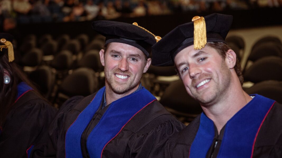 Blake and Lucas are all smiles on Newman graduation day.