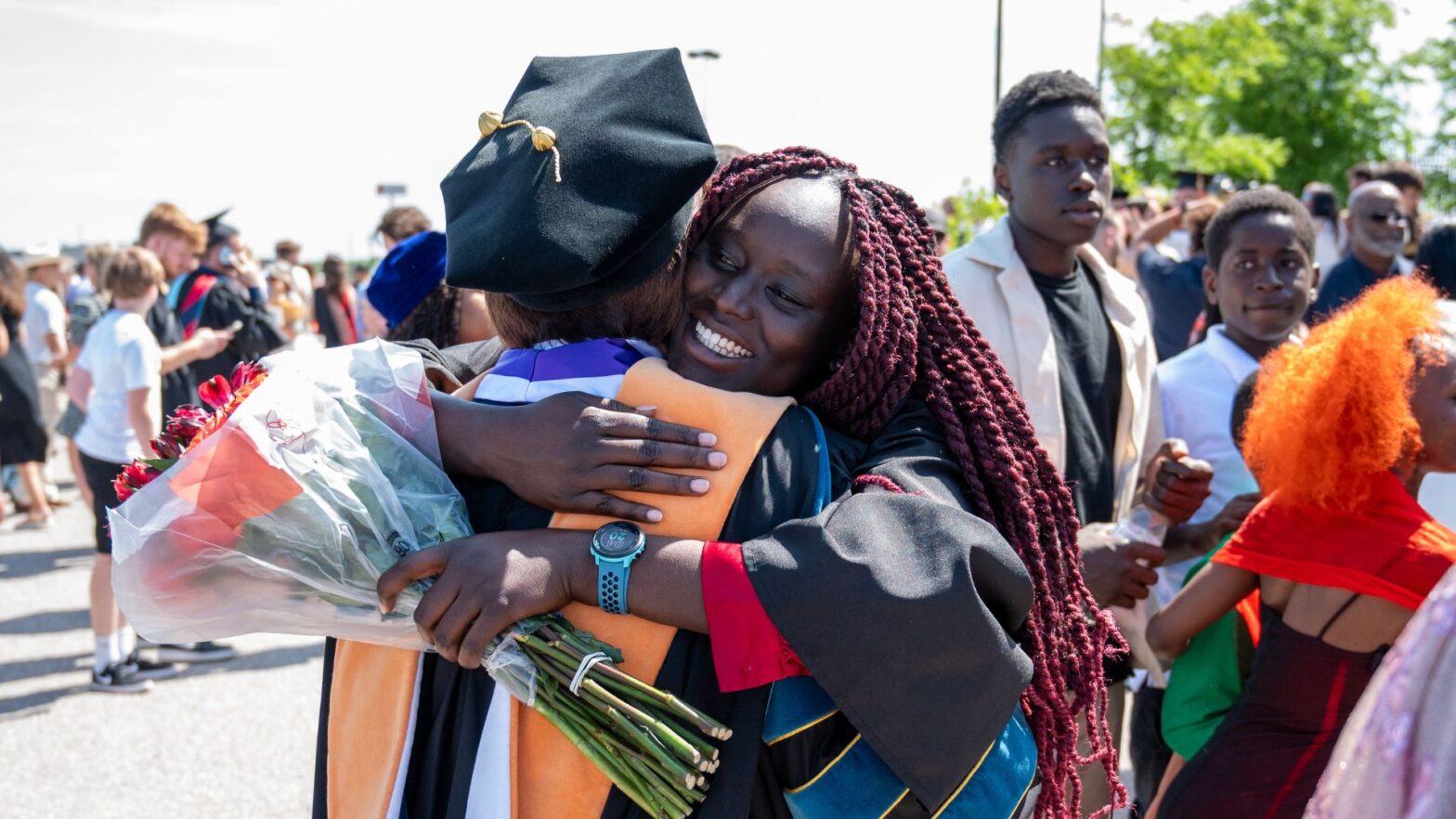 Limo hugs one of her nursing professors after Newman University's 2025 commencement ceremony.