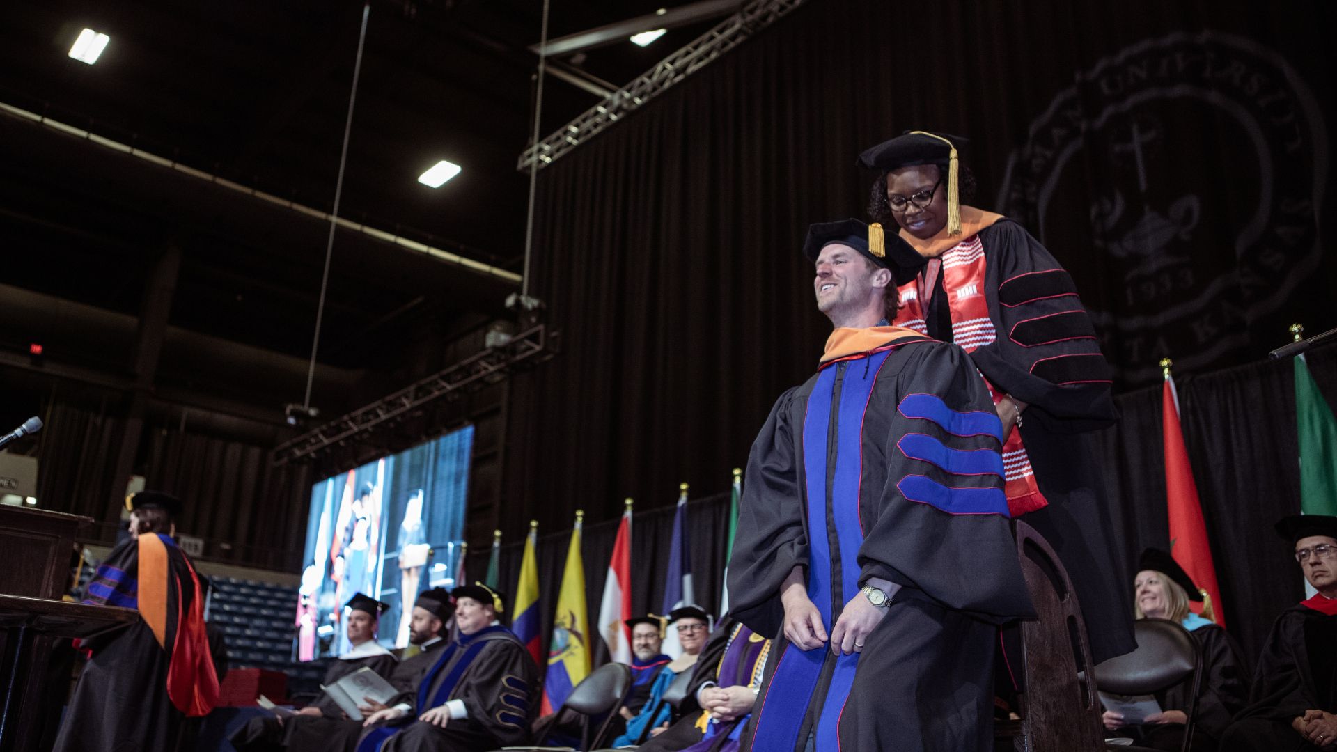 Lucas receives his ceremonial hood from Brent, director of the DNAP program.