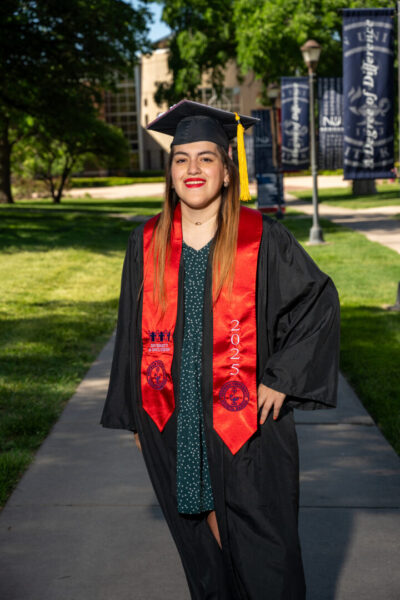 Campa wears her Newman graduation cap and gown on campus.