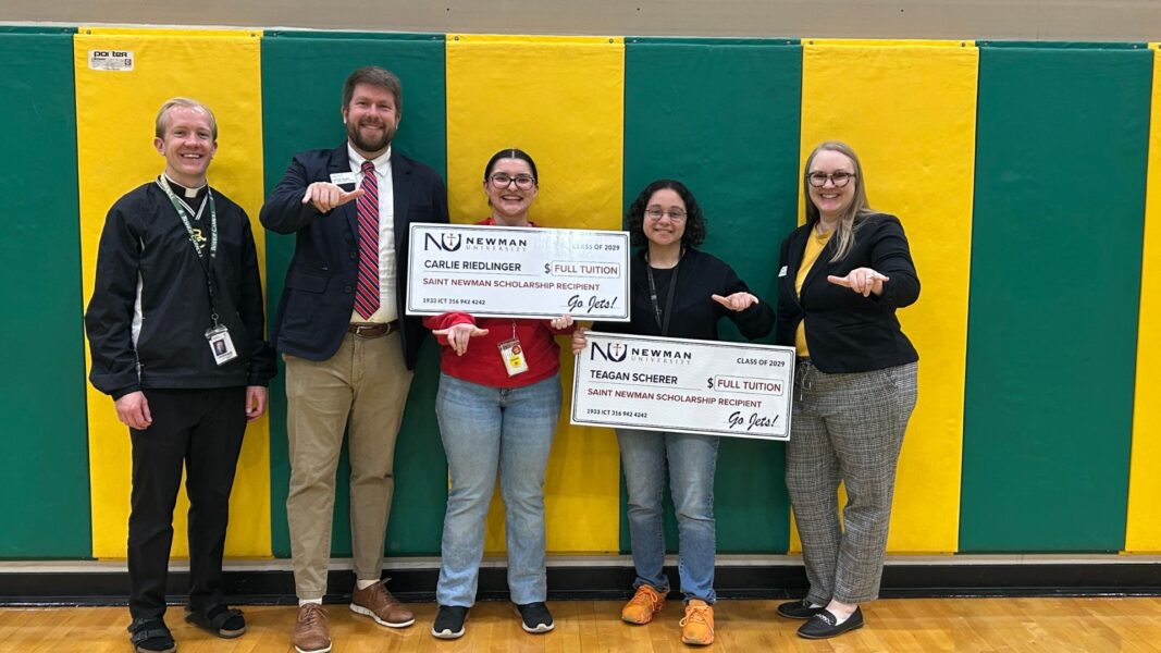 Scherer (second from right) holds her scholarship check with fellow St. Newman Scholarship recipient Carlie Riedlinger at Bishop Carroll High School.