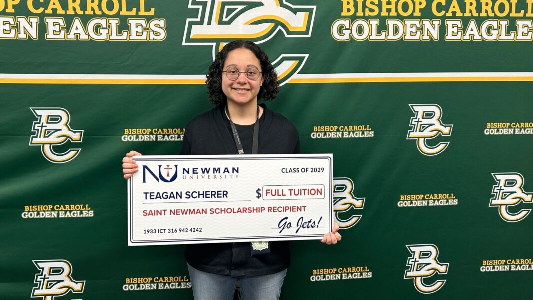 Scherer holds her check in the amount of "full tuition."