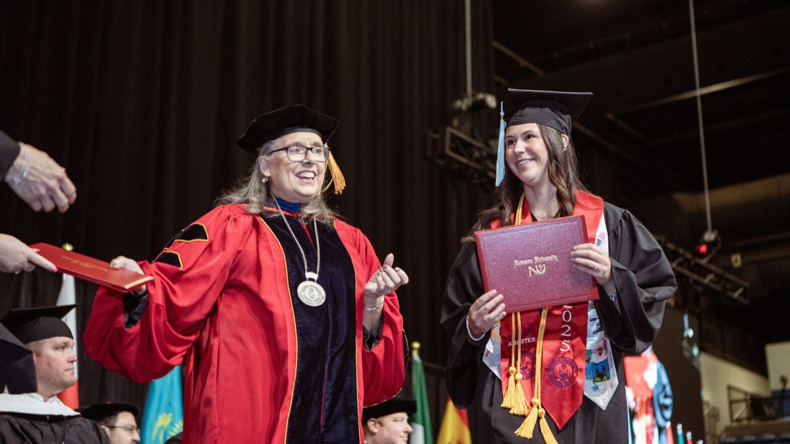 Kindred receives her degree from Newman President Kathleen Jagger during graduation.