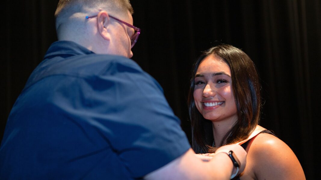 Szewczyk receives her ceremonial nursing pin from Director of Nursing Ashton Clarkson.