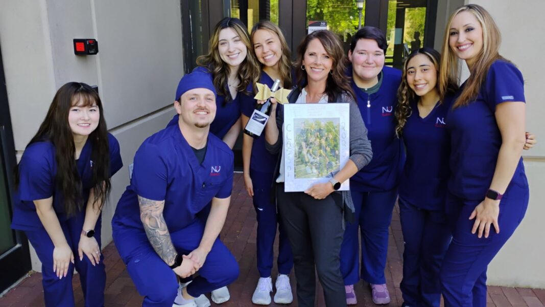 Herd (far left) and classmates surprise Instructor/Clinical Coordinator of the Radiologic Technology Program Sherry Ewing with end-of-semester gifts.
