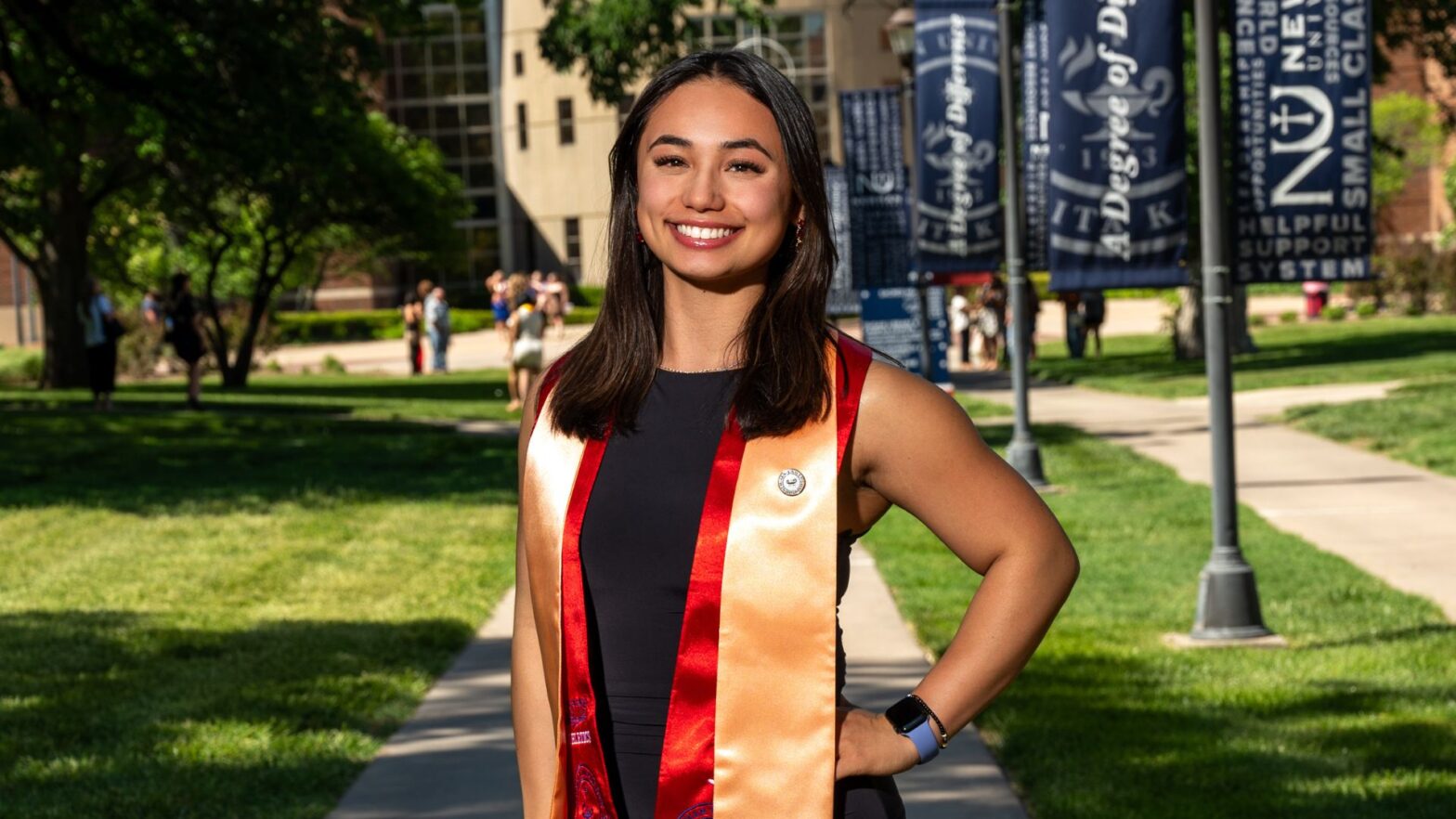 Szewczyk wears her graduation stoles on the Newman University campus.