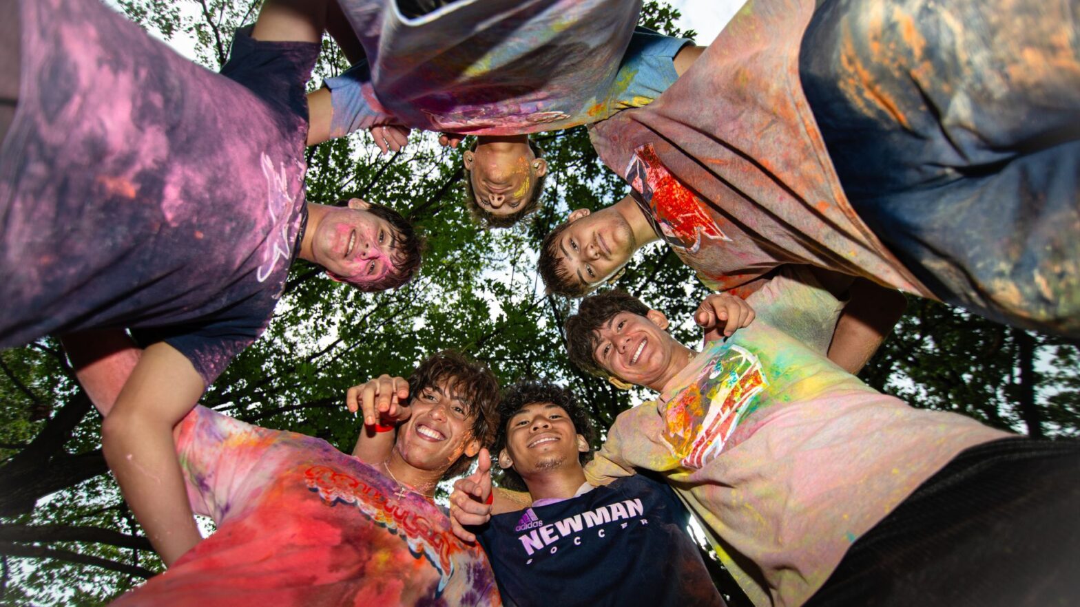 Students huddle after the Newman University Color Run.