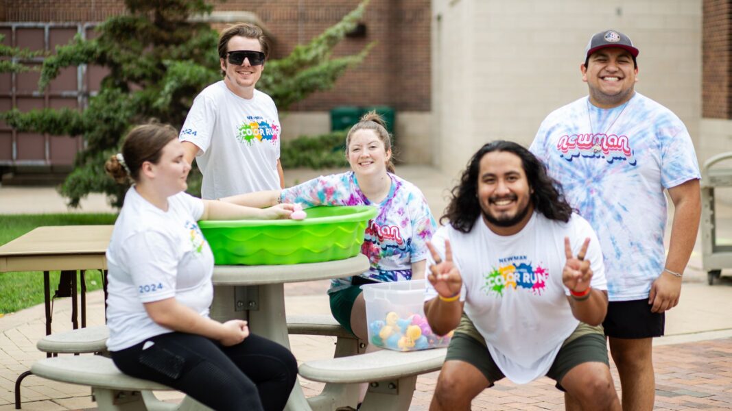 Student and staff volunteers run the duck station during the carnival portion of the Color Run event.