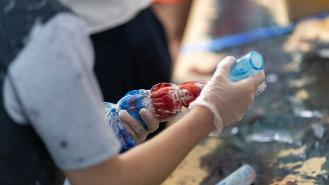 A student tie-dyes a T-shirt during back-to-school week.