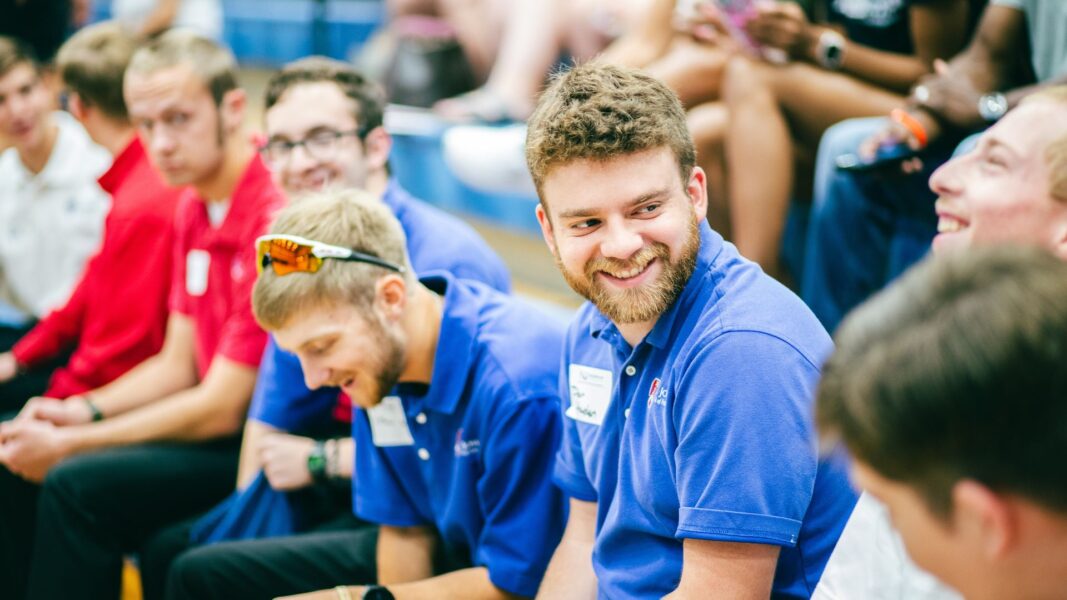 Students smile in the gym during new student orientation.