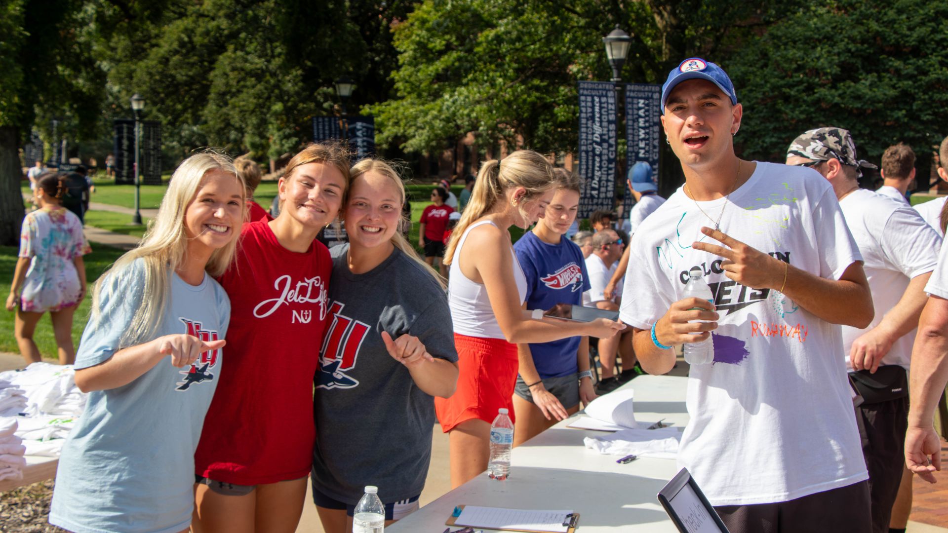 Students gather around a registration table at Newman University.