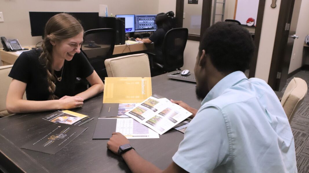 Strickbine looks at company marketing materials with fellow McCurdy intern Lotsu-Morgan.