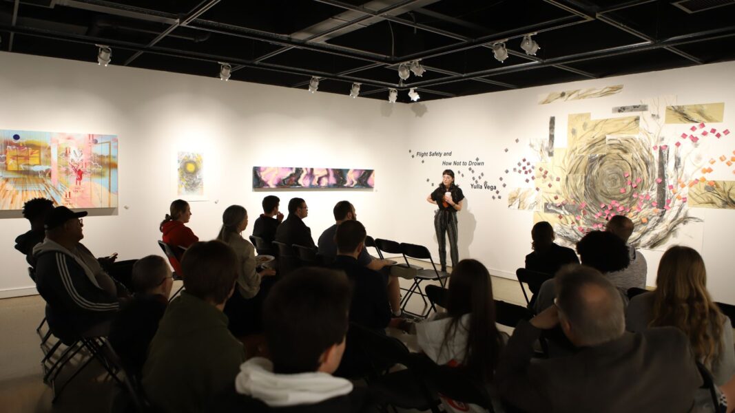 Featured artist Yulla Vega presents for students during Art for Lunch in the Steckline Gallery.