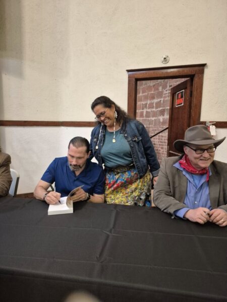 Mark (right) and other cast members participate in a meet and greet event.