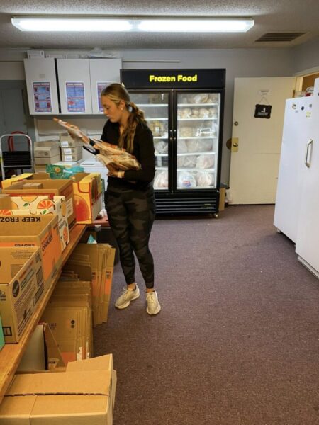 Women's soccer team volunteers at Shepherd's Heart Food Pantry.