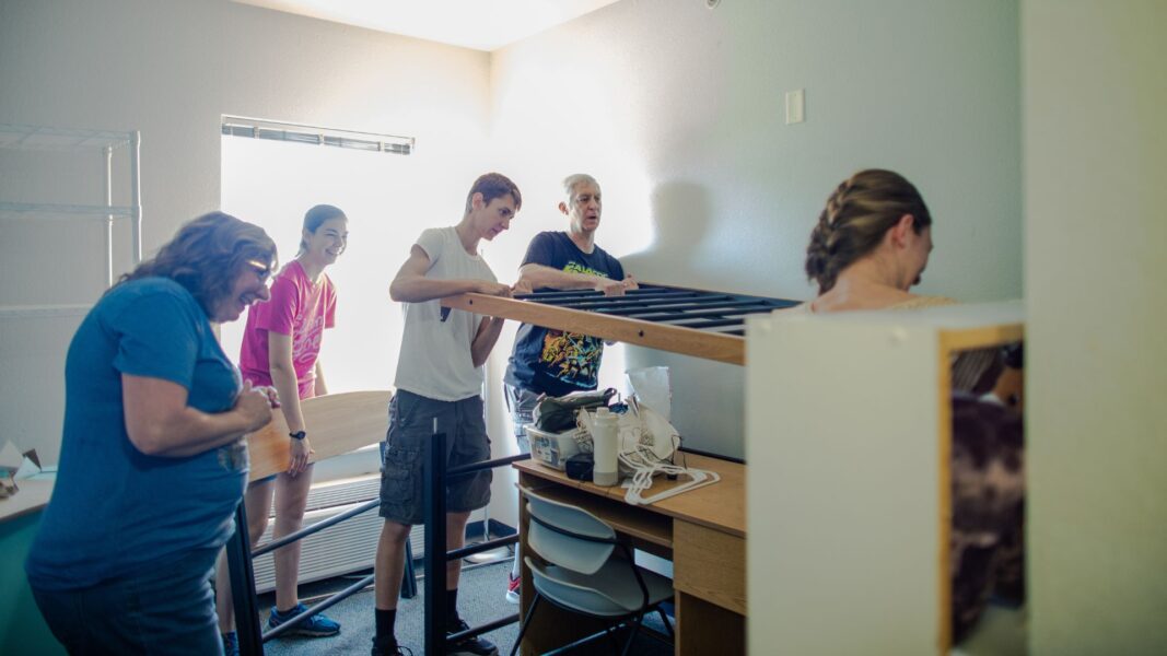The Strickbine family (including Susan, left) help first-year student Anna move into Carrocci Hall.