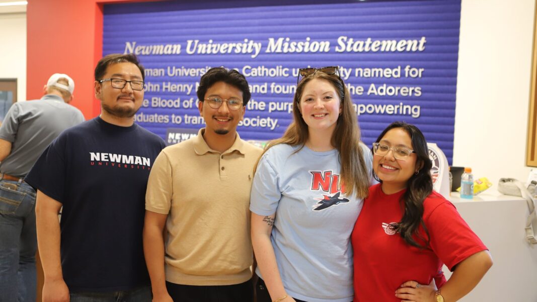 Students wear their Newman gear during an Admissions event.